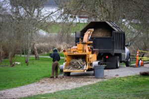 Industrial wood chipping machine feeding into a commercial truck