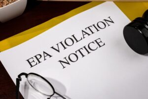 EPA Violation Notice Document Set on Wooden Desk
